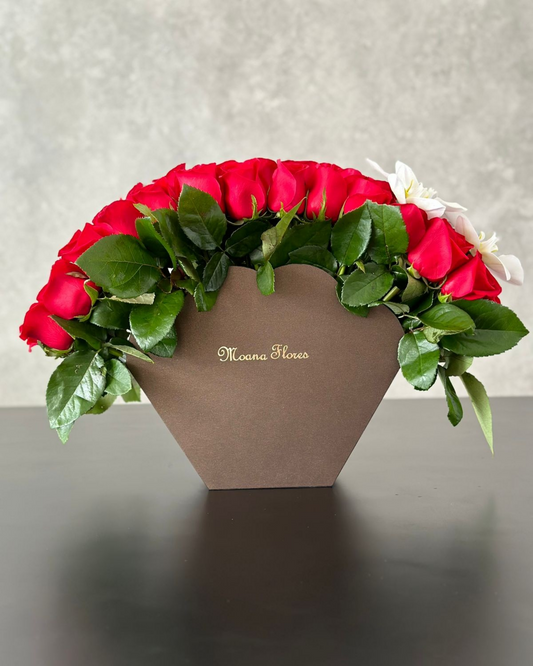 Rosas rojas con follaje y orquídeas blancas en abanico