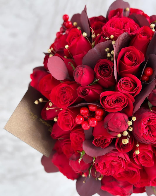 Domo rosas rojas con follajes cálidos.